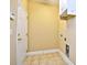 The laundry room includes tile flooring, storage cabinets, and washer/dryer hookups at 6172 Catalina Dr. # 214, North Myrtle Beach, SC 29582