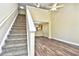 Open-concept living room featuring beautiful wood floors and staircase to upper level at 6172 Catalina Dr. # 214, North Myrtle Beach, SC 29582