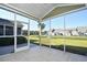 Enclosed screened porch with tile flooring providing views of the landscaped yard and nearby homes at 6172 Catalina Dr. # 214, North Myrtle Beach, SC 29582