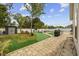 Beautifully landscaped backyard featuring a paved patio, manicured lawn, and storage shed at 649 W Perry Rd., Myrtle Beach, SC 29579