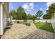 Large backyard with paved patio, manicured lawn, and a charming fire pit area at 649 W Perry Rd., Myrtle Beach, SC 29579