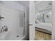 Bright bathroom with walk-in shower with glass door and white tile at 649 W Perry Rd., Myrtle Beach, SC 29579