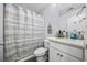 Cozy bathroom with a vanity, a toilet, and a bathtub with a striped shower curtain at 649 W Perry Rd., Myrtle Beach, SC 29579