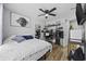 Cozy bedroom featuring hardwood floors, ceiling fan, and a large lion art print at 649 W Perry Rd., Myrtle Beach, SC 29579
