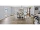 Sunlit dining room featuring hardwood floors and modern chandelier at 649 W Perry Rd., Myrtle Beach, SC 29579