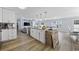Modern kitchen with stainless steel appliances, an island, and seamless flow into the living space at 649 W Perry Rd., Myrtle Beach, SC 29579