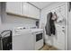 Functional laundry room with modern washer and dryer units and cabinet storage at 649 W Perry Rd., Myrtle Beach, SC 29579