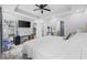 Spacious main bedroom with tray ceilings, carpet, and access to the ensuite bathroom and the living room at 649 W Perry Rd., Myrtle Beach, SC 29579