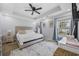Bright main bedroom with tray ceilings, a ceiling fan, carpet and large windows at 649 W Perry Rd., Myrtle Beach, SC 29579