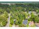Aerial view of neighborhood features mature trees with scattered houses at 6612 Wintergreen Point, Myrtle Beach, SC 29588