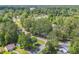 An aerial view showing mature trees and some homes nestled among them at 6612 Wintergreen Point, Myrtle Beach, SC 29588