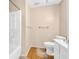 A simple bathroom features a white shower, toilet, and sink with minimal decor at 6612 Wintergreen Point, Myrtle Beach, SC 29588