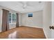 Inviting bedroom with wood floors, a ceiling fan, and a window providing natural light at 6612 Wintergreen Point, Myrtle Beach, SC 29588