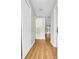 Bright hallway with wood floors leading to a living area with sliding glass doors at 6612 Wintergreen Point, Myrtle Beach, SC 29588