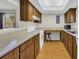 Cozy kitchen featuring wood cabinets, a white electric range, and a sunlit ambiance from the ceiling light at 6612 Wintergreen Point, Myrtle Beach, SC 29588