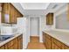 Kitchen featuring wood cabinets, white appliances, and an adjacent cutout to another room at 6612 Wintergreen Point, Myrtle Beach, SC 29588