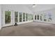 Bright sunroom with door and windows provides great natural light and views of backyard trees at 6612 Wintergreen Point, Myrtle Beach, SC 29588
