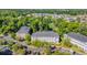 Aerial view of condo complex surrounded by trees, landscaping, and parking at 683 Riverwalk Dr. # 302, Myrtle Beach, SC 29579