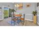 Cozy dining area featuring a round table, comfortable chairs, and sliding glass door, great for relaxation at 683 Riverwalk Dr. # 302, Myrtle Beach, SC 29579