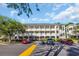 A multi-story condo building featuring white railings and stairs with ample parking at 683 Riverwalk Dr. # 302, Myrtle Beach, SC 29579