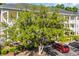 A large green tree is set in front of a yellow building at 683 Riverwalk Dr. # 302, Myrtle Beach, SC 29579