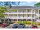 Condominium building exterior featuring multiple floors, exterior staircases, and manicured landscaping at 683 Riverwalk Dr. # 302, Myrtle Beach, SC 29579