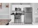A modern kitchen with white cabinets, stainless steel appliances, and a granite countertop at 683 Riverwalk Dr. # 302, Myrtle Beach, SC 29579