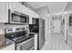 Modern kitchen featuring stainless steel appliances, granite countertops, and ample cabinet space at 683 Riverwalk Dr. # 302, Myrtle Beach, SC 29579
