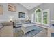 Bright living room featuring large windows and comfortable furnishings, ideal for relaxation at 683 Riverwalk Dr. # 302, Myrtle Beach, SC 29579