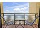 Balcony with table and chairs overlooking the beach and ocean, perfect for outdoor dining at 6900 Ocean Blvd. # 935, Myrtle Beach, SC 29572