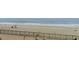 Relaxing beach view from property showing lifeguard station, chairs, and distant figures by the ocean at 6900 Ocean Blvd. # 935, Myrtle Beach, SC 29572