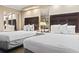 Bright bedroom featuring two queen beds, ambient lighting, and mirrored closet doors, enhancing space and style at 6900 Ocean Blvd. # 935, Myrtle Beach, SC 29572