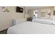 Cozy bedroom features two beds, a TV, and a cute dining table and wicker dresser at 6900 Ocean Blvd. # 935, Myrtle Beach, SC 29572