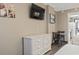 Comfortable bedroom featuring two beds, TV, wicker dresser, and dining table next to the kitchen at 6900 Ocean Blvd. # 935, Myrtle Beach, SC 29572