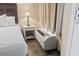 Cozy bedroom showcases a bedside lamp, wicker nightstand, and modern air conditioning unit for comfort and style at 6900 Ocean Blvd. # 935, Myrtle Beach, SC 29572