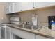 Efficient kitchen with white cabinetry, granite countertops, and modern appliances, offering a functional cooking space at 6900 Ocean Blvd. # 935, Myrtle Beach, SC 29572