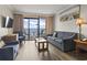 Bright living room with comfortable seating, ocean view, and access to a private balcony at 6900 Ocean Blvd. # 935, Myrtle Beach, SC 29572
