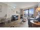 Comfortable living room with seating, wood floors, coastal themed decor, and balcony access at 6900 Ocean Blvd. # 935, Myrtle Beach, SC 29572