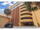 Multi-level parking garage next to tropical palms provides ample parking for residents and visitors at 6900 Ocean Blvd. # 935, Myrtle Beach, SC 29572