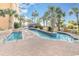 Outdoor pool area featuring a lazy river, chairs, and palm trees at 6900 Ocean Blvd. # 935, Myrtle Beach, SC 29572