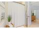 Clean bathroom showcases a white shower curtain, rattan side table, and decorative elements at 708 Ashland Ave., North Myrtle Beach, SC 29582