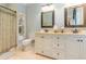 Elegant bathroom featuring double sinks, stylish mirrors, a toilet, and built-in shelving at 708 Ashland Ave., North Myrtle Beach, SC 29582