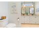 Well-lit bathroom with double vanity, decorative mirrors, and stylish fixtures exudes elegance at 708 Ashland Ave., North Myrtle Beach, SC 29582