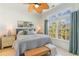Inviting bedroom with ceiling fan, large window, and framed wall art creates a relaxing ambiance at 708 Ashland Ave., North Myrtle Beach, SC 29582