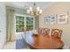 Elegant dining room with a large wood table, chandelier lighting, and a picturesque window view at 708 Ashland Ave., North Myrtle Beach, SC 29582