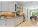 Well-appointed kitchen with granite countertops, custom cabinets, stainless appliances, and a view into the dining area at 708 Ashland Ave., North Myrtle Beach, SC 29582