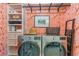 Charming laundry room boasts flamingo wallpaper, modern machines, and shelving with ample storage at 708 Ashland Ave., North Myrtle Beach, SC 29582