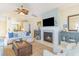 Inviting living room boasts a fireplace, comfortable seating, neutral decor, and seamless flow into the kitchen at 708 Ashland Ave., North Myrtle Beach, SC 29582