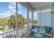 Relaxing screened-in porch with comfortable seating overlooking a street with mature trees at 708 Ashland Ave., North Myrtle Beach, SC 29582