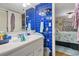 Bright bathroom with vibrant blue tile and convenient bedroom access at 806 Conway St. # 116, North Myrtle Beach, SC 29582